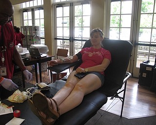 Neighbors | Jessica Harker .Sophia Grenzig sat and donated blood at the Poland library on June 21.