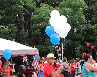Neighbors | Jessica Harker.A Bridge of Hope volunteer held a bundle of baloons he was passing out to attendees during the Boardman Park's fireworks event.