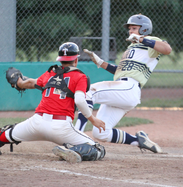 William D. Lewis The Vindicator Baird'sDylan Swarmer(28) scores while Troy catcher(14) triw to make the tag during 7-19-18 game with Troy at Cene.