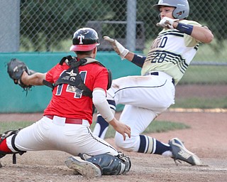 William D. Lewis The Vindicator Baird'sDylan Swarmer(28) scores while Troy catcher(14) triw to make the tag during 7-19-18 game with Troy at Cene.