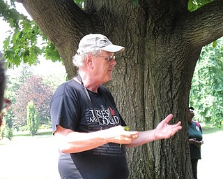 Neighbors | Jessica Harker.Jim Chatfield discussed the importance of local trees while he stood outside next to a red oak at the Mill Creek Park.