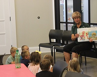 Neighbors | Abby Slanker.Peg Flynn of the Mahoning Valley Green Team read children the Sesame Street book “From Trash to Treasure” by Liza Alexander featuring characters such as Oscar the Grouch and Bert and Ernie during Rock Out with the Green Team at the Canfield library on July 12.