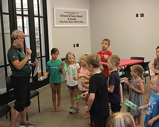 Neighbors | Abby Slanker.Peg Flynn of the Mahoning Valley Green Team led attendees of Rock Out with the Green Team in singing the “Recycling Song” during which the children shook the instruments they created at the Canfield library on July 12.