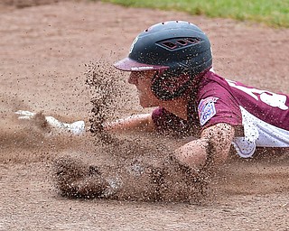 NORTH CANTON, OHIO - JULY 22, 2018: Boardman's Jack Ericson slides into third base to avoid being caught in a rundown in the fifth inning of a Little League baseball game, Sunday night in North Canton. DAVID DERMER | THE VINDICATOR