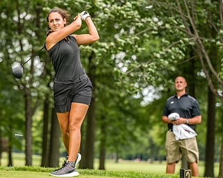 DIANNA OATRIDGE | THE VINDICATOR Carly Ungaro, from Poland, tees off as her caddie, Eric Ungaro, looks on during the final round of the Greatest Golfer junior tournament at Avalon Lakes in Howland on Saturday.