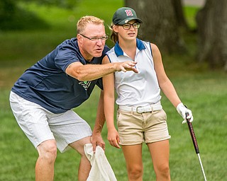 DIANNA OATRIDGE | THE VINDICATOR Leah Benson, from Hermitage, gets advice from her coach and caddie, Scott Bradley, as she prepares to putt during the final round of the Greatest Golfer junior tournament at Avalon Lakes in Howland on Saturday.