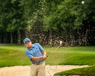 DIANNA OATRIDGE | THE VINDICATOR Nolan Williard, from Canfield, hits out of a bunker during the final round of the Greatest Golfer junior tournament at Avalon Lakes in Howland on Saturday.