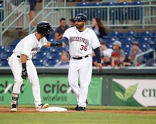 Clark Scolamiero fist bumps Omir Santos after getting on first during Tuesday night's game against the Cyclones.