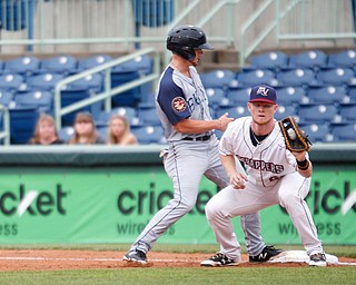 Scrappers first baseman Mitch Reeves catches the ball to try to get Cyclones's Chandler Avant out on his way back to first during Tuesday night's game.