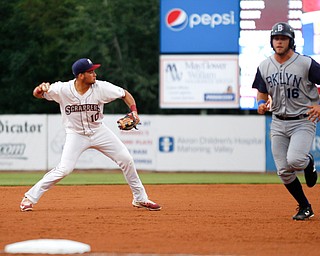 Henry Pujols throws the ball to first as the Cyclones's Kevin Hall runs past during Tuesday night's game.