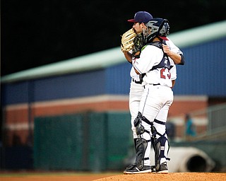 Scrappers' pitcher Zach Draper and catcher Angel Lopez talk on the mound during the fourth inning of Tuesday night's game.
