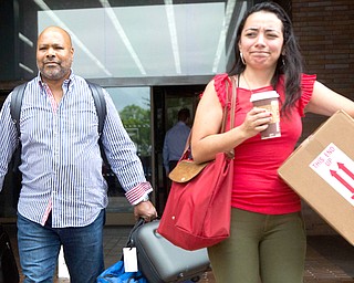 New York Daily News photo assignment editor Reggie Lewis, left, and an unidentified coworker leave the newspaper's office after they were both laid off, Monday, July 23, 2018, in New York. The tabloid will cut half of its newsroom staff, saying it wants to focus more on digital news. (AP Photo/Mark Lennihan)