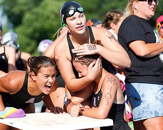 Sarah Bero, 11, left, and Mary Catherine Werth, 12, right, hugs Alex Ward, 11, after she gets out of the water, while she and Sarah Bero, 11, left, cheer for their APP teammates competing in the 200Y Medley Relay during the swim meet between Applewood Swim Club and Boardman Tennis and Swim Club at the Applewood Swim and Tennis Club on Wednesday.