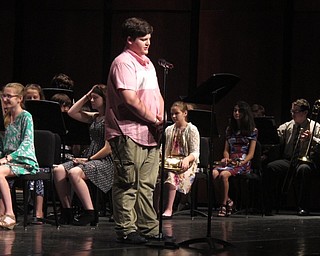 Neighbors | Zack Shively.Musical teachers Michael Shevock and Timothy Tuite directed the three bands that performed at the spring band concert. They had students read introductions to each of the songs. Pictured, a student introduced "Thinking Out Loud."