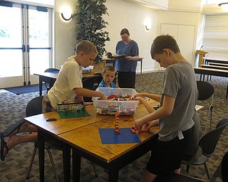 Neighbors | Jessica Harker.Zach Hans and Noah Friendman built structures with Legos at the Austintown library on June 22.