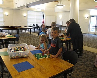 Neighbors | Jessica Harker.Delana and John Ragaon built a Lego house together at the June 22 Austintown Legos in the library event.