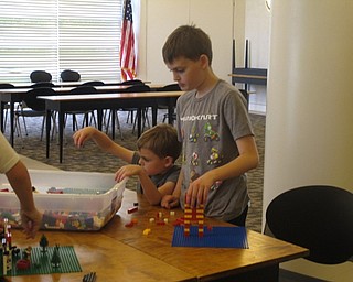 Neighbors | Jessica Harker.Liam and Noah Friedman are pictured building with Legos at the Austintown library on June 22.