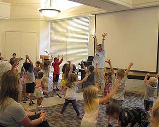Neighbors | Jessica Harker.Allison Graf, the youth services librarian at Austintown, led the group of children in song at the June 28 Gotta Move story time event.