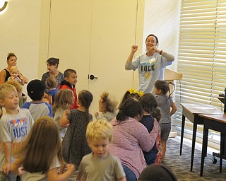 Neighbors | Jessica Harker.Allison Graf, the youth services librarian at Austintown, danced to "Shake My Sillies," with the group of children gathered at the Gotta Move story time on June 28.
