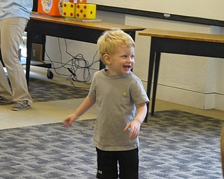 Neighbors | Jessica Harker.Peter Ledbetter danced during the reading of "Yoga Frog" at the June 28 Gotta Move story time at the Austintown library.