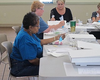 Neighbors | Jessica Harker.Participants practiced cleaning icing tips before decorating cookies on June 26 at the beginners cookie decorating class.