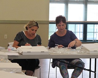 Neighbors | Jessica Harker.Participants used the edible markers to draw lines on their cookies to help decorate during the beginners cookie decorating class on June 26.