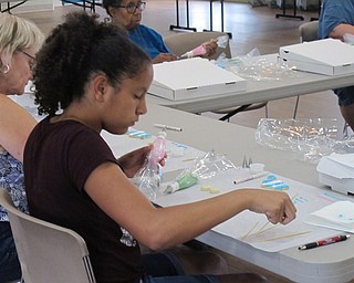Neighbors | Jessica Harker.Participants used tooth picks to spread icing while decorating cookies on June 26 at the beginners cookie decorating class at the MetroParks Farm.