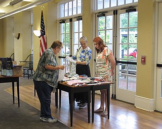 Neighbors | Jessica Harker .Participants picked out fabric to creat personalized coasters at the DIY coaster making event at the Poland library June 26.