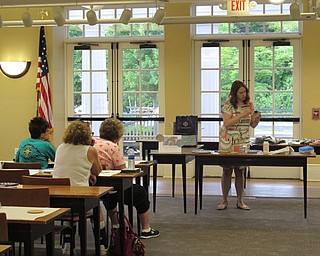 Neighbors | Jessica Harker.Missy Williams, the librarian for adult programing, instructed the class on how to make DIY coasters at the Poland library June 26.