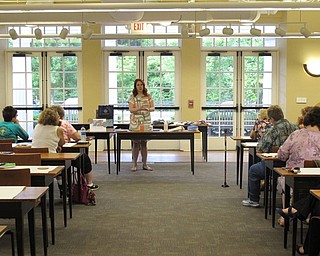 Neighbors | Jessica Harker .Missy Williams, the librarian for adult programming, instructed the class on how to make DIY coasters at the Poland library June 26.