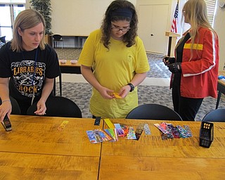 Neighbors | Natalie Wright.A selection of plastic strips in a variety of colors and patterns were available for participants at the DIY Guitar Picks event to choose from. A pick punch was used to make the guitar picks from the plastic strips.