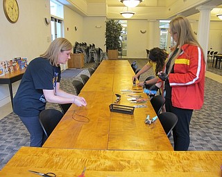 Neighbors | Natalie Wright.Participants of the DIY Guitar Picks event at the Austintown library made guitar picks and key chains under the guidance of librarian Lyndsay Cramer on July 18.