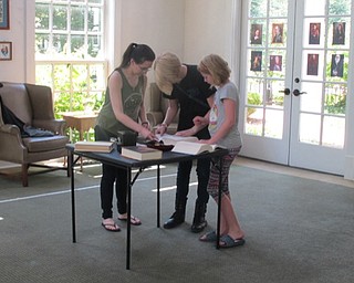 Neighbors | Natalie Wright.The first team at the Poland library's Escape Hogwarts event worked together to compare the clues they had found. Clues could be inside books, on items, written in invisible ink and more.