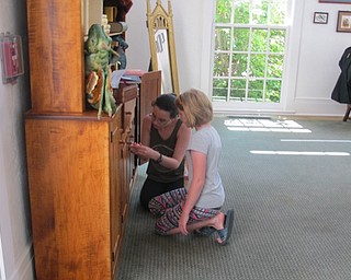 Neighbors | Natalie Wright.Two participants worked together to put in the correct combination on a lock on a bureau at the Poland library. They hoped to find more clues to the Diadem of Rowena Ravenclaw's location so they could complete the escape room challenge.