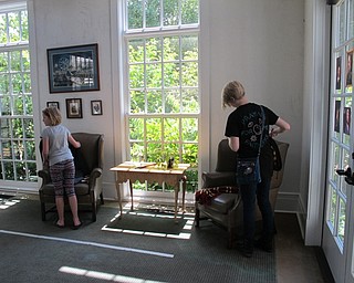 Neighbors | Natalie Wright.Two participants looked through the cloaks and scarf props that were part of the Escape Hogwarts event at the Poland library on July 19.