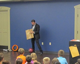 Neighbors | Natalie Wright.Magician and illusionist David Anthony made a bowling ball drop out of a seemingly empty paper bag. The bowling ball was later used in a juggling stunt.