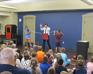 Neighbors | Natalie Wright.Two volunteers helped David Anthony perform a Houdini-style trick involving escaping from a set of handcuffs while having his hands tied within a bag. Anthony incorporated humor into the stunt by magically slipping into and out of the cuffs during the explanation prior to the trick.