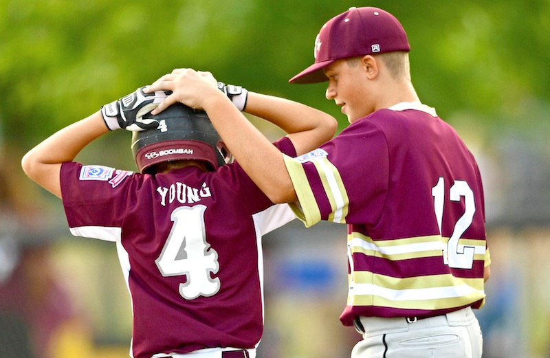 New Albany first baseman Max Purper (12) consoles Boardman batter Charlie Young after their game Thursday in the Little League 11-12 state tournament in North Canton. Boardman lost 3-1 to drop into the losers bracket. They could meet again on Saturday.