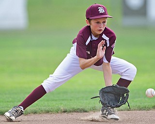 NORTH CANTON, OHIO - JULY 26, 2018: Boardman's Matt Kay fields a ball before throwing to first for the out in the second inning of a Little League baseball game, Thursday night in North Canton. New Albany won 3-1. DAVID DERMER | THE VINDICATOR