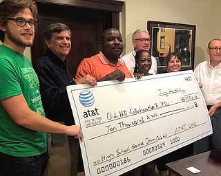 Showing off a $10,000 contribution today from AT&T are, from left, Austin Vingle, Steve Kritstin, Mayor Jamael Tito Brown, Satonia Johnson, Pat Kerrigan, Kendra Corpier and Dr. Coskun Bayrak.