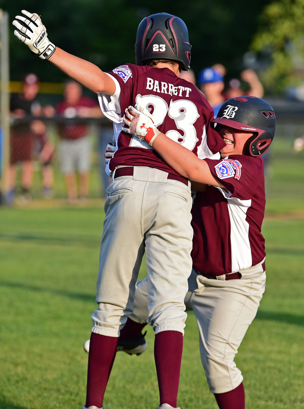 NORTH CANTON, OHIO - JULY 17, 2018: Boardman's Tyler Kirlik, right, is congratulated by XXX after hitting a walk off single with the bases loaded to beat Hamilton 5-4 in the sixth inning of a Little League baseball game, Friday night in North Canton. DAVID DERMER | THE VINDICATOR