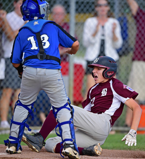 NORTH CANTON, OHIO - JULY 17, 2018: Boardman's Jack Ericson slides into home to score after hitting a inside the park home run off Hamilton starting pitcher Jonathan Alcorn in the fifth inning of a Little League baseball game, Friday night in North Canton. Boardman won 5-4. DAVID DERMER | THE VINDICATOR