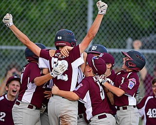 NORTH CANTON, OHIO - JULY 17, 2018: Boardman's Jack Ericson is mobbed by his tames after hitting a inside the park home run off Hamilton starting pitcher Jonathan Alcorn in the fifth inning of a Little League baseball game, Friday night in North Canton. Boardman won 5-4. DAVID DERMER | THE VINDICATOR