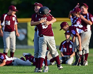 NORTH CANTON, OHIO - JULY 17, 2018: Boardman's XXX, front, is hugged by Caleb Satterfield after hitting a walk off single with the bases loaded to beat Hamilton 5-4 in the sixth inning of a Little League baseball game, Friday night in North Canton. DAVID DERMER | THE VINDICATOR