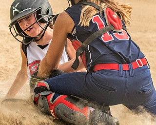DIANNA OATRIDGE | THE VINDICATOR Austintown Fitch's Kylie Folkwein tags out Canfield's Marina Koenig as she slides into home during  10 U tournament action in Tallmadge on Monday. Canfield won 18-4.