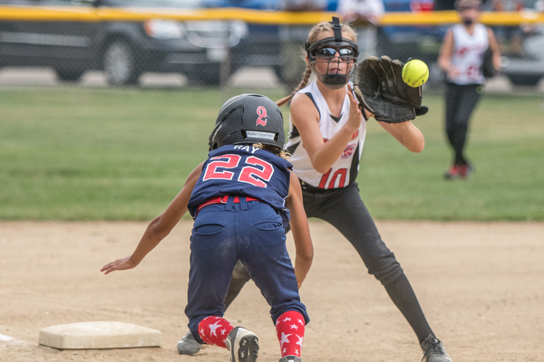 DIANNA OATRIDGE | THE VINDICATOR Austintown's Kali Ray dives back to third base as Canfield's Sam Economous catches the throw to third during 10U state tournament action in Tallmadge on Monday. Canfield won 18-4 to advance to the championship.