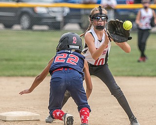 DIANNA OATRIDGE | THE VINDICATOR Austintown's Kali Ray dives back to third base as Canfield's Sam Economous catches the throw to third during 10U state tournament action in Tallmadge on Monday. Canfield won 18-4 to advance to the championship.