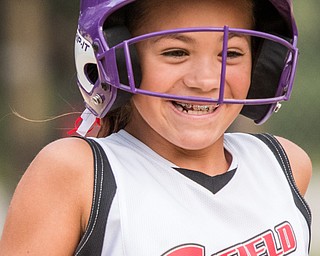 DIANNA OATRIDGE | THE VINDICATOR Canfield's Riley Billak smiles after drawing a walk during the Cardinals' convincing 18-4 win over Austintown Fitch during 10 U state tournament action in Tallmadge on Monday.