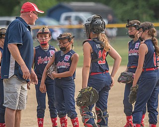 DIANNA OATRIDGE | THE VINDICATOR Members of the Austintown Fitch 10 U softball team convene on the mound during a timeout during 10 U state tournament action in Tallmadge on Monday. Canfield won 18-4.