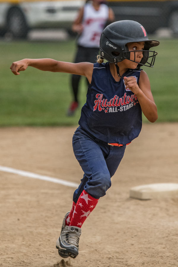 DIANNA OATRIDGE | THE VINDICATOR Austintown's Kali Ray rounds third and heads home to score a run during 10U state tournament action against Canfield in Tallmadge on Monday. Canfield won 18-4 to advance to the championship.